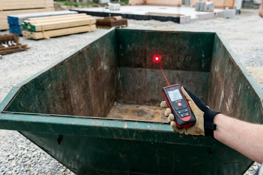 How to estimate waste volume accurately with a laser distance measurer pointed inside an empty green skip.